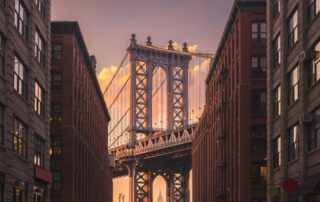 Brooklyn bridge seen between two buildings